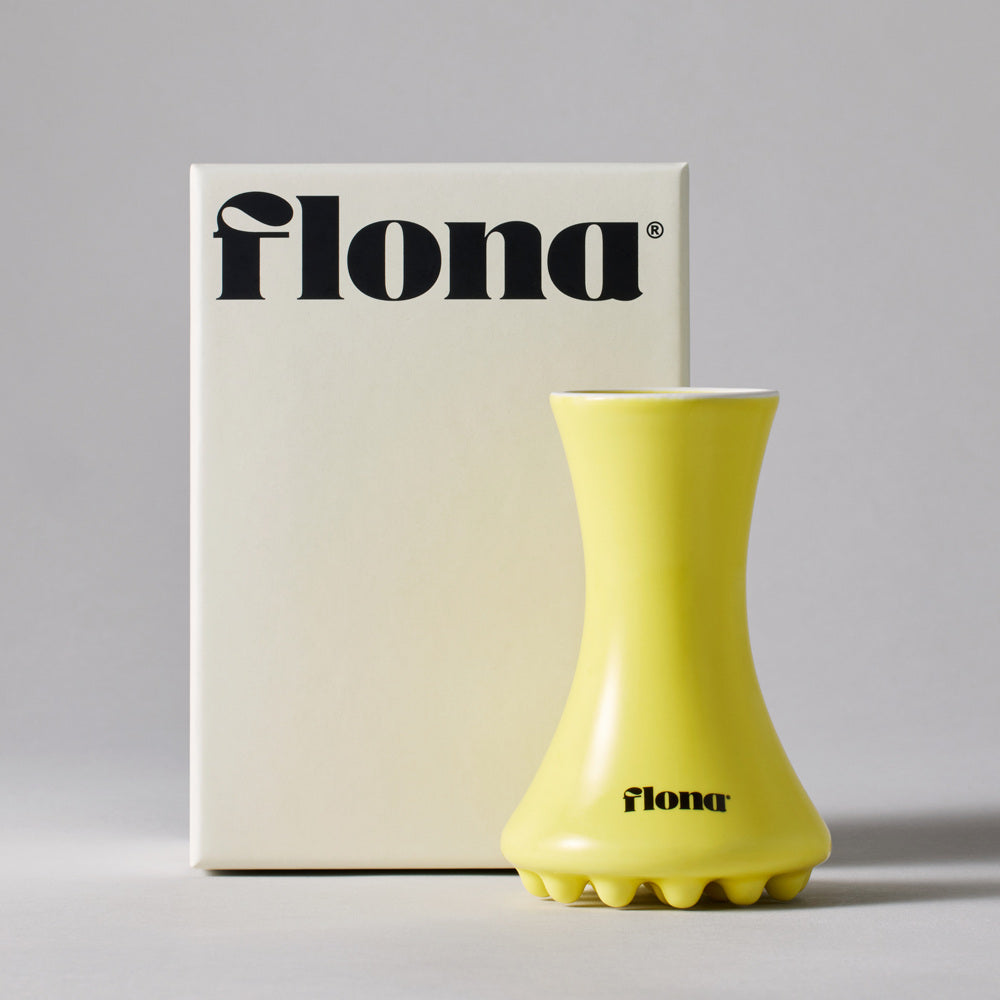 Flona Ceramic Face Gua Sha in Yellow with its retail box.