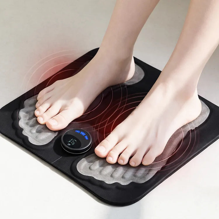 Black bodypim EMS foot massager with bare feet on the shaped pads