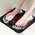 Black bodypim EMS foot massager with bare feet on the shaped pads