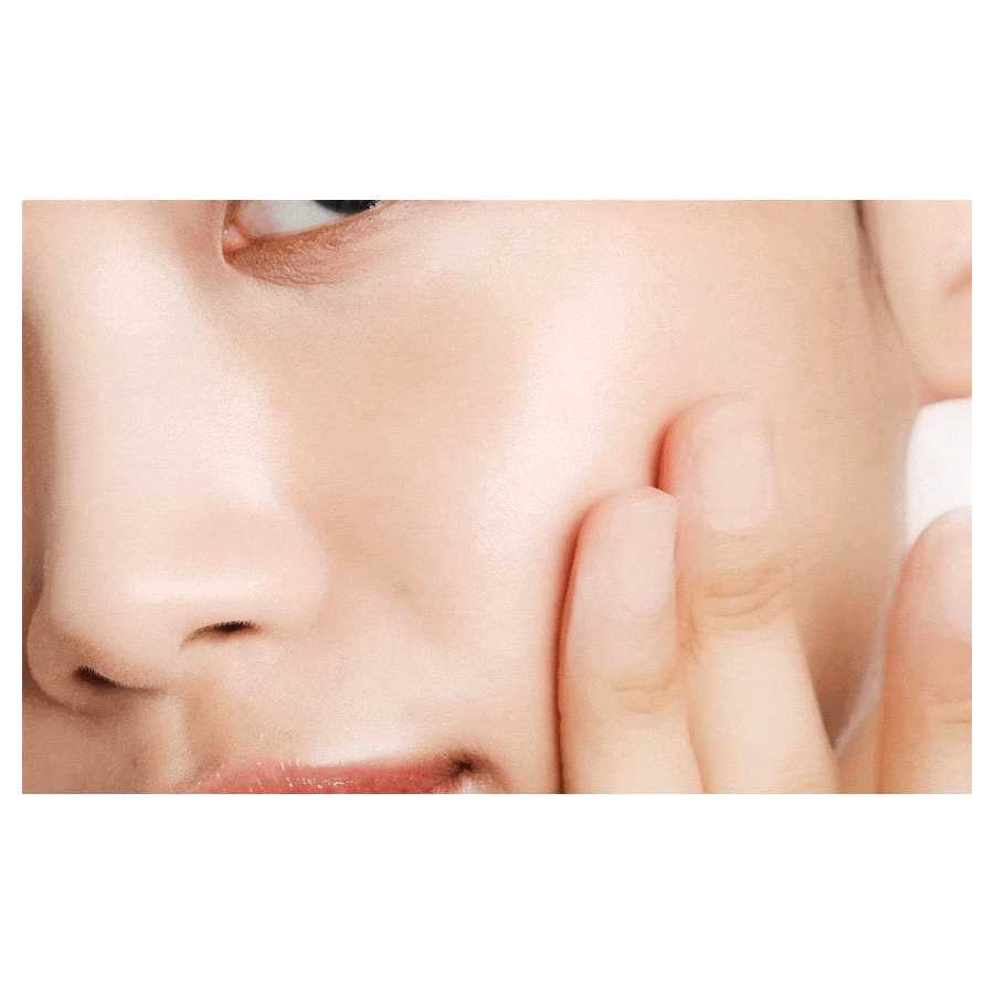 Primera Vita-Tinol serum patted onto the cheek in the actual manufacturer application demonstration