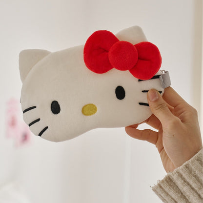 INKO Hello Kitty Heated Eye Mask in white with a red bow, held to show the full front.