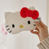 INKO Hello Kitty Heated Eye Mask in white with a red bow, held to show the full front.