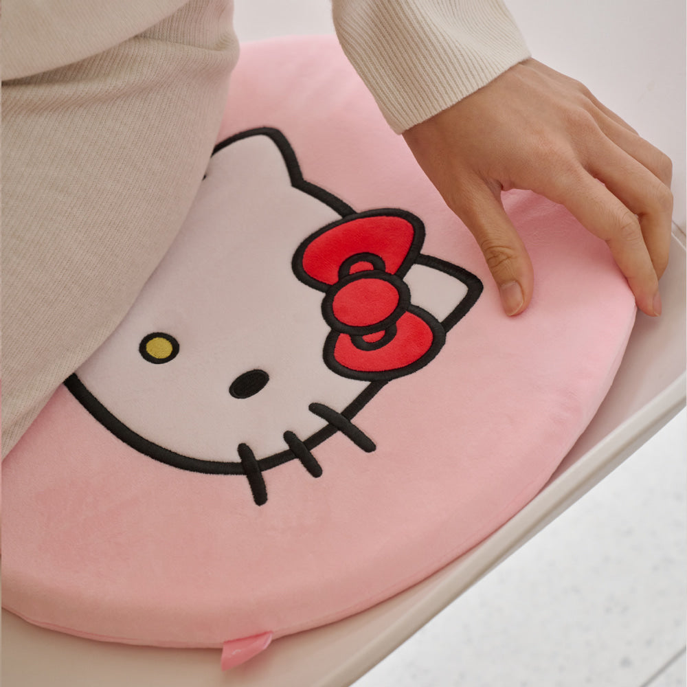 Pink INKO Hello Kitty Heated Memory Foam Seat Cushion showing the embroidered character and soft surface.