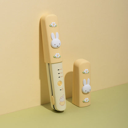 Yellow ROYCHE miffy wireless mini flat iron with its separate silicone safety cap.